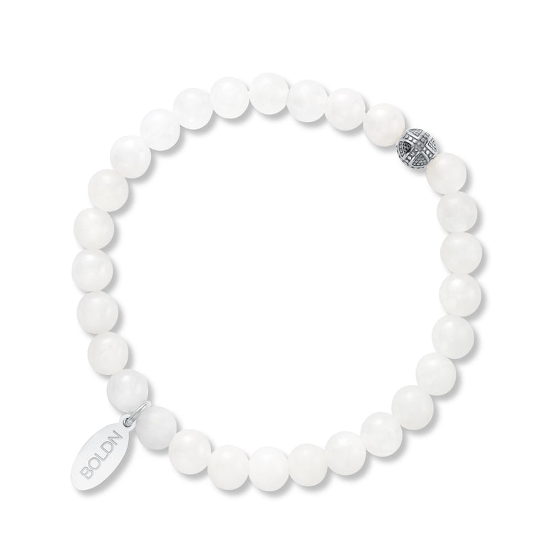White beaded bracelet with a silver tag on a white background