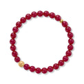 Red beaded bracelet with gold accents on a white background