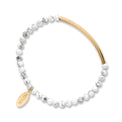 Bracelet with white beads and gold accents on a white background